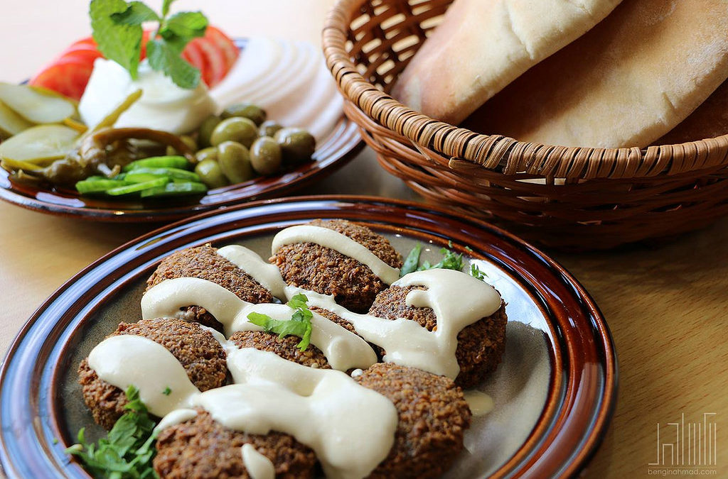 Falafel on a Plate with a Basket of Pita